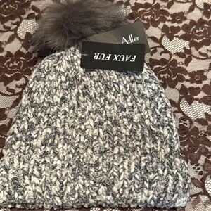 Marcus Adler women's knit beanie with a faux fur pom.